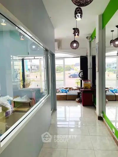 Bright hallway with large windows and modern lighting in commercial space