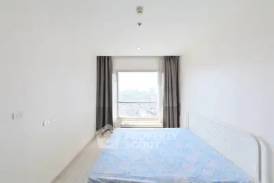 Bright bedroom with large window offering stunning city view, minimalist decor and ample natural light.