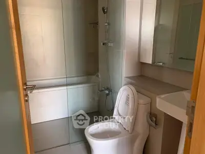 Modern bathroom with glass shower and sleek fixtures
