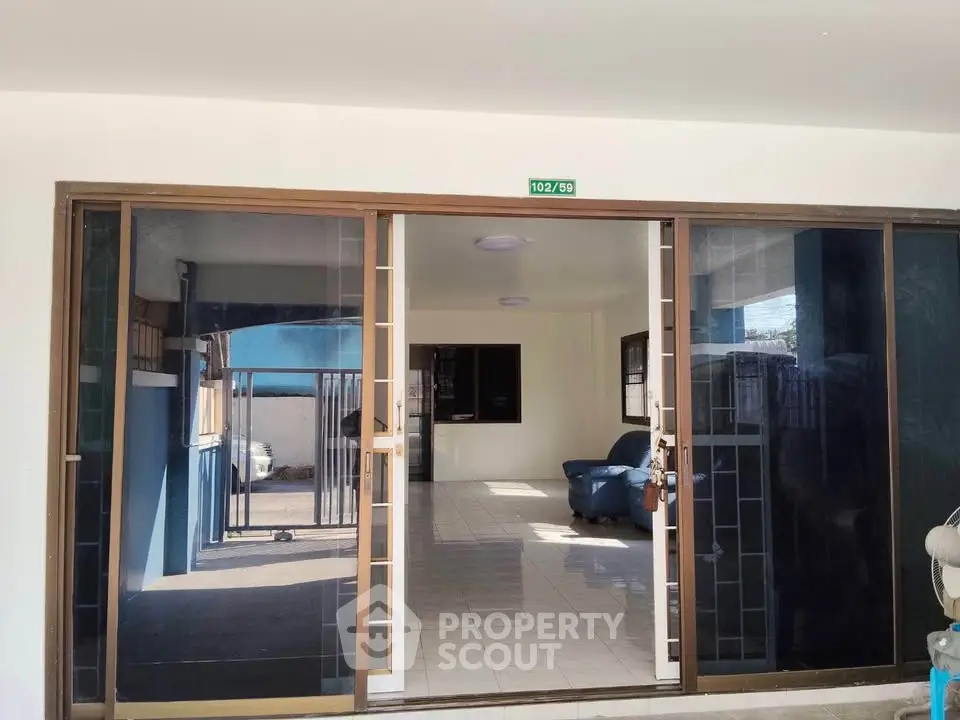 Spacious living room with sliding glass doors and ample natural light