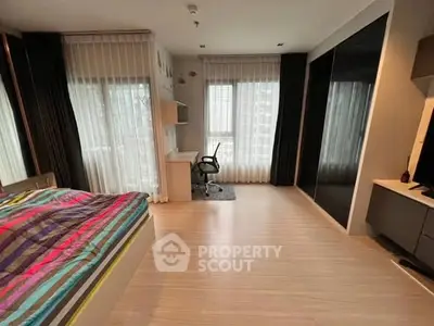 Modern bedroom with study area and large windows in stylish apartment