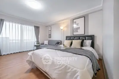 Spacious modern bedroom with stylish decor and natural light