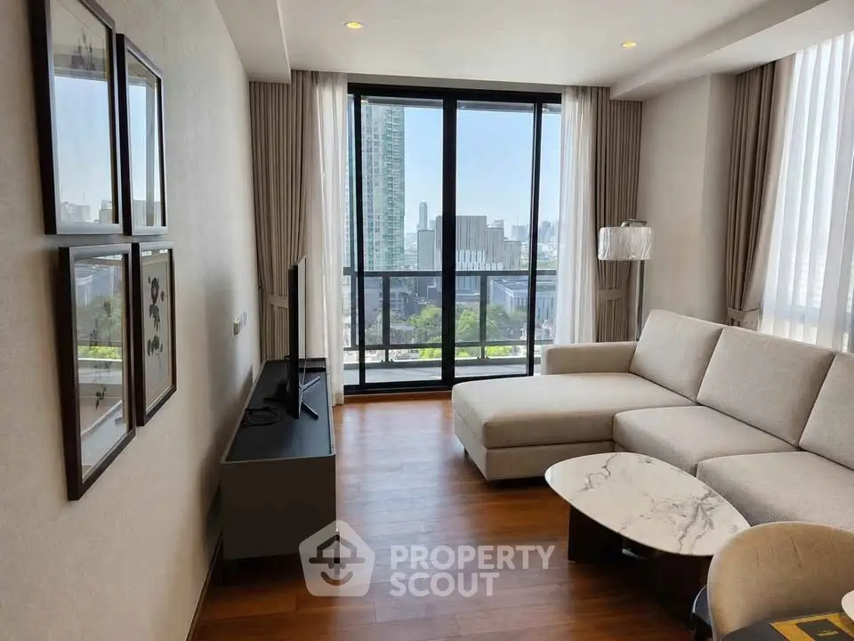 Modern living room with large windows and city view, featuring a stylish sofa and wooden flooring.