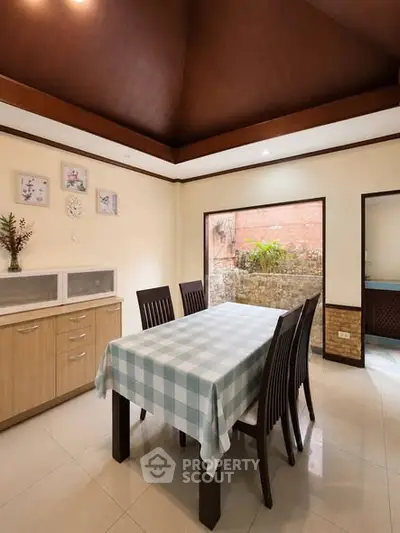 Spacious dining area with elegant wooden ceiling and natural light