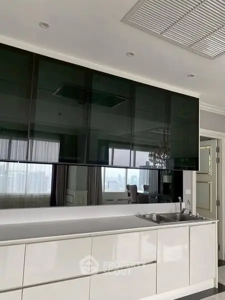 Luxurious modern kitchen with sleek cabinetry and city view