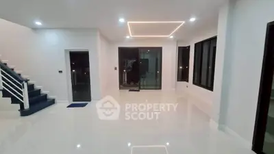 Spacious modern living room with sleek lighting and glossy floors