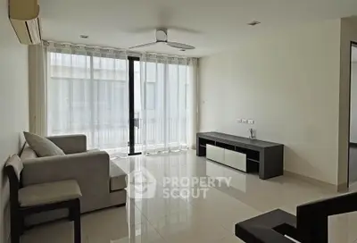 Spacious modern living room with sleek furniture and large windows
