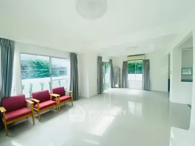 Spacious and bright living room with large windows and modern decor