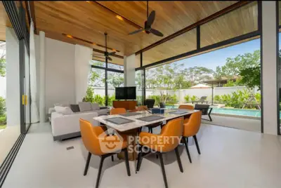 Luxurious open-plan living room with pool view and modern decor
