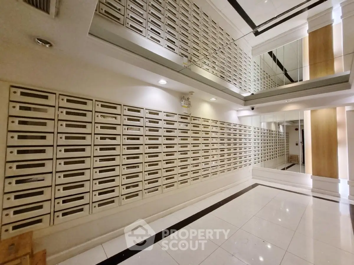 Modern apartment building entrance with sleek mailboxes and mirrored walls