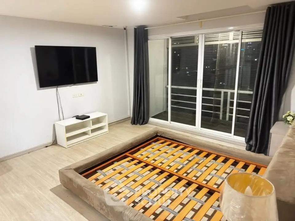 Spacious living room with modern decor and large window for natural light.