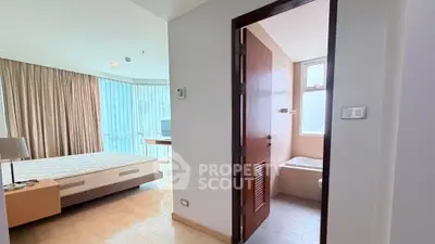 Spacious bedroom with ensuite bathroom in modern apartment, featuring large windows and natural light.