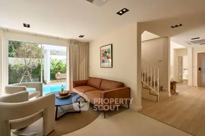 Modern living room with pool view and stylish furniture