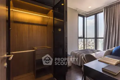 Modern bedroom with walk-in closet and panoramic city view, featuring sleek design and natural light.