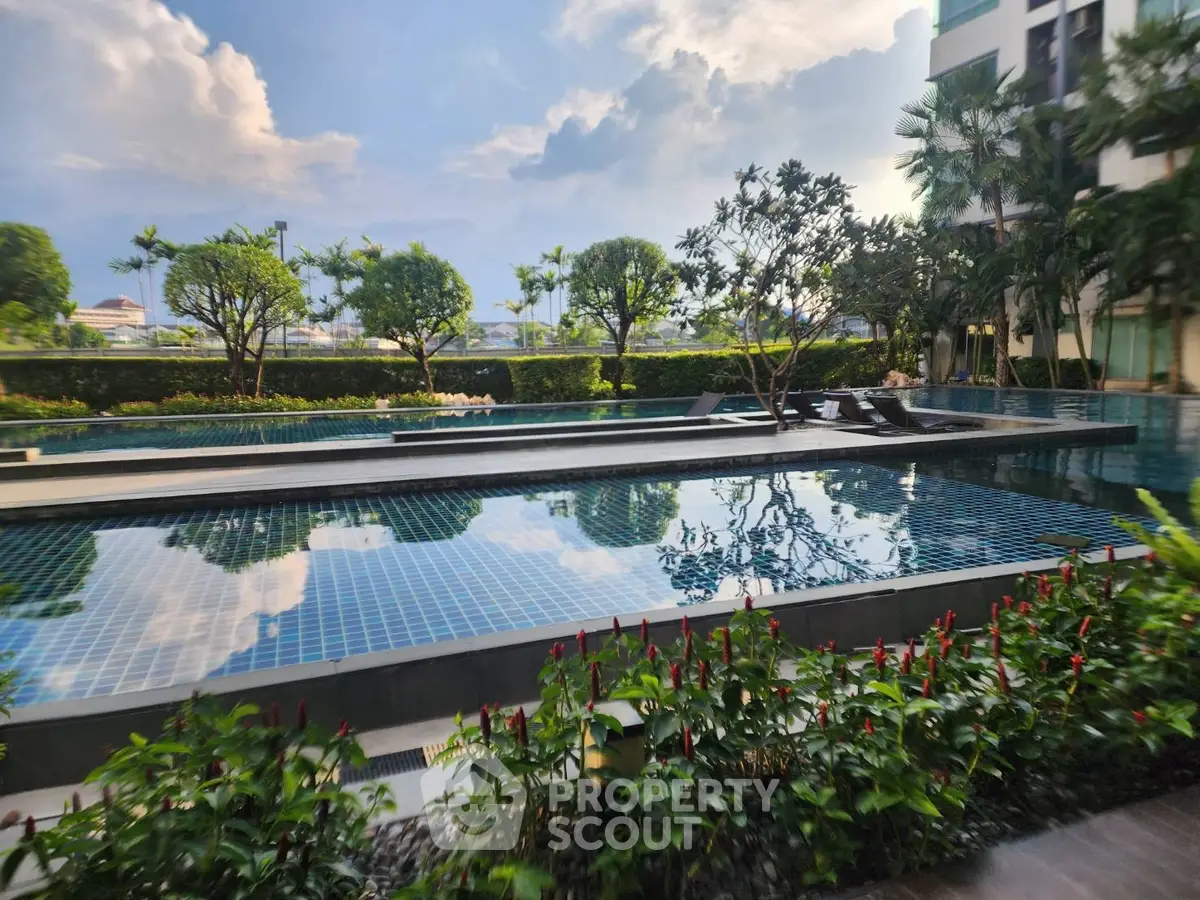 Luxurious poolside view with lush greenery and modern architecture