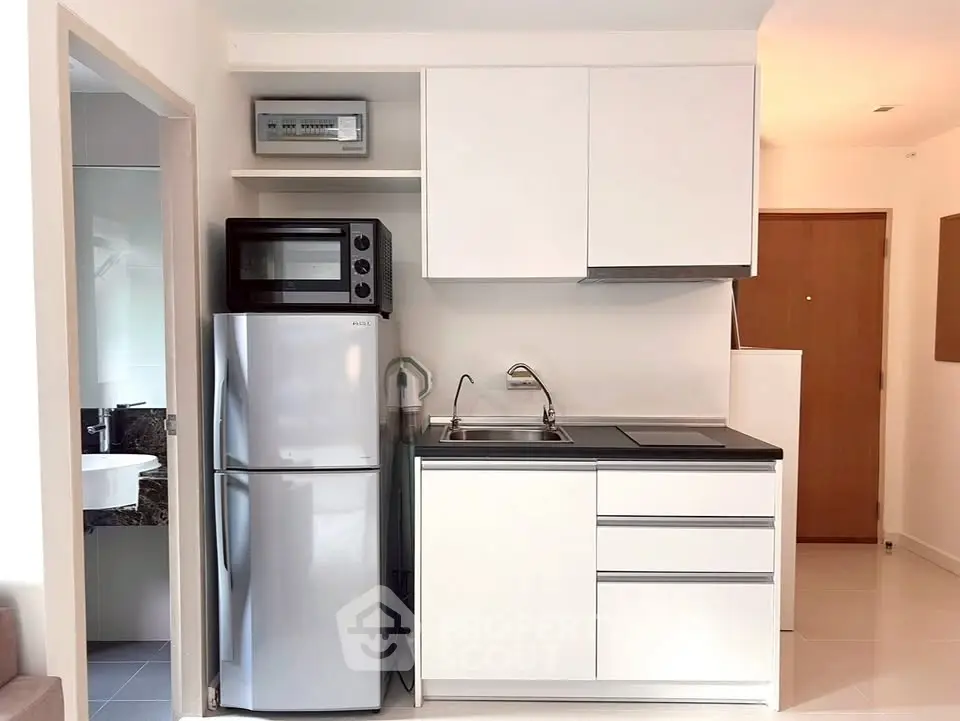 Modern compact kitchen with sleek appliances and minimalist design