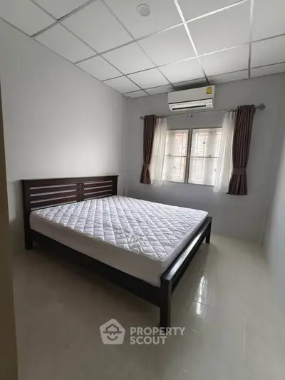 Spacious bedroom with modern bed and air conditioning, perfect for comfort and relaxation.