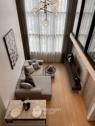 Modern loft-style living room with high ceilings and elegant decor