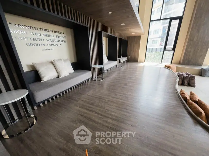 Modern lobby with stylish seating and large windows in a contemporary building.