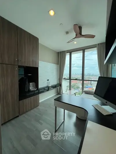 Modern study room with city view, sleek desk, and built-in storage cabinets.