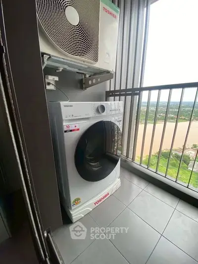 Modern balcony with washing machine and scenic river view, perfect for urban living.
