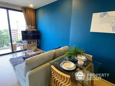 Modern living room with blue accent wall and balcony view