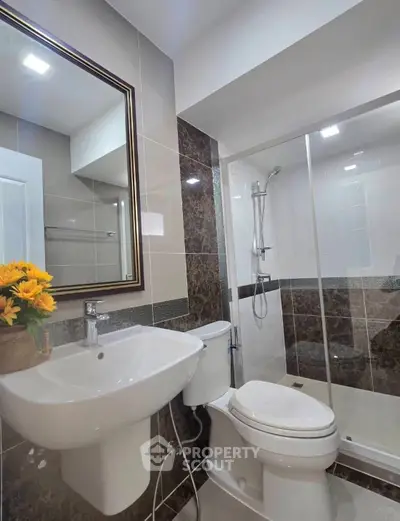 Modern bathroom with sleek fixtures and glass shower enclosure