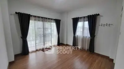 Spacious empty room with large windows and elegant curtains, perfect for customization.