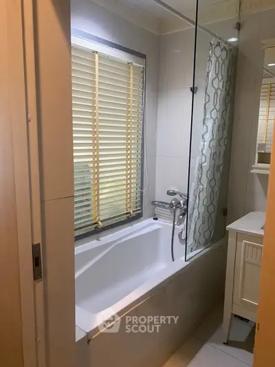 Modern bathroom with bathtub and stylish blinds