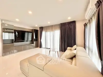 Spacious modern living room with elegant curtains and plush sofa