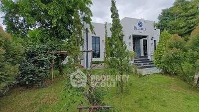 Charming modern building surrounded by lush greenery, perfect for serene living.