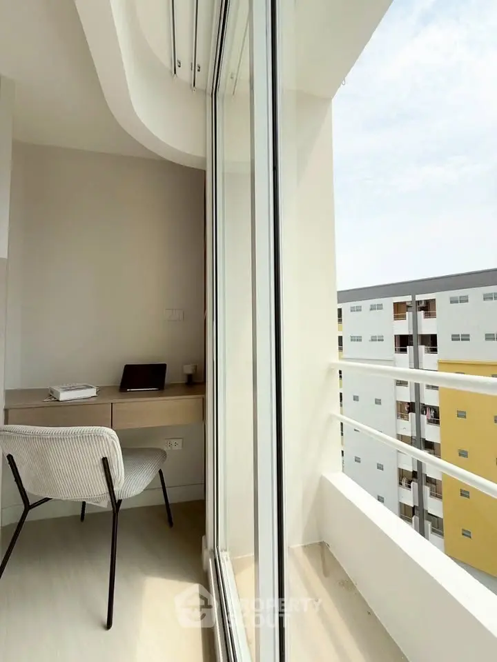 Modern apartment with study nook and balcony offering city views