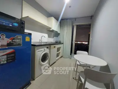 Modern kitchen with appliances and dining area, featuring a city view from the window.