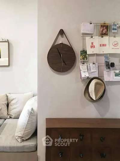 Cozy living room corner with stylish wall clock and organized bulletin board.