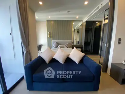 Modern studio apartment with stylish blue sofa and elegant decor