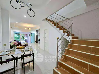 Modern dining area with staircase and open layout, perfect for family gatherings.