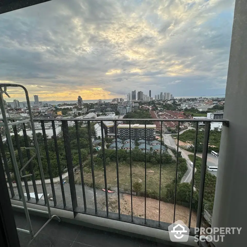 Stunning cityscape view from high-rise balcony at sunset, perfect for urban living.