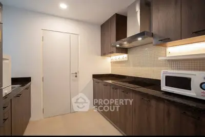 Modern kitchen with sleek cabinets and built-in appliances
