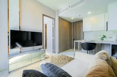Modern living room with sleek design, featuring a wall-mounted TV and stylish furniture in a bright apartment.