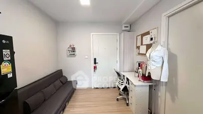 Modern study room with sleek desk, comfortable sofa, and stylish decor in a cozy apartment.