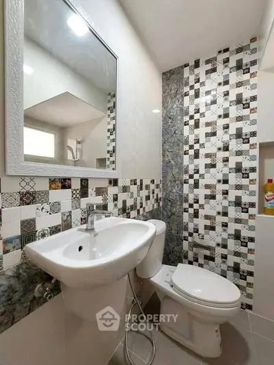 Modern bathroom with stylish tile design and sleek fixtures.