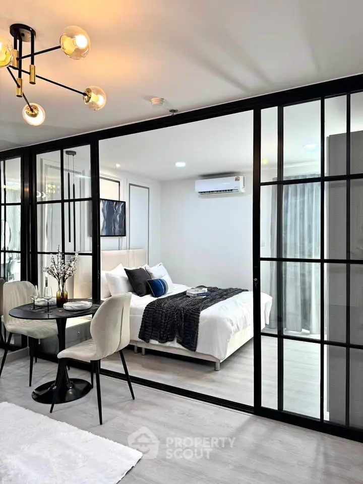 Modern bedroom with glass partition and stylish dining area
