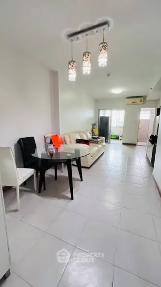 Modern living room with elegant lighting and cozy seating area in a stylish apartment.