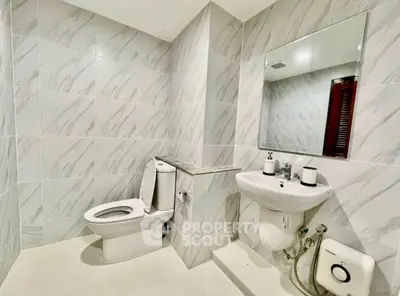 Modern bathroom with sleek fixtures and elegant tile design, perfect for a contemporary home.