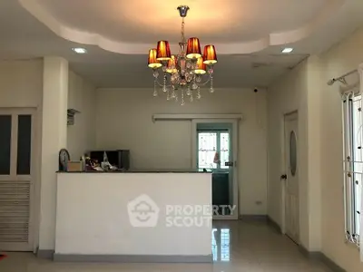 Charming interior with elegant chandelier and spacious layout, perfect for modern living.