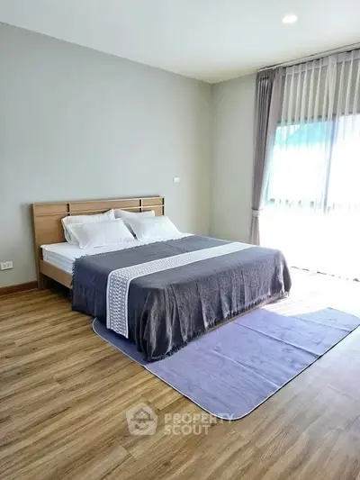 Spacious bedroom with modern decor and natural light