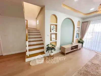 Stylish living room with modern decor and elegant staircase