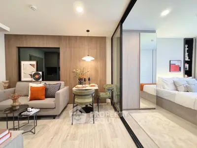 Modern living room with stylish decor and cozy dining area in open-plan apartment