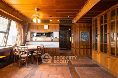 Charming vintage dining room with wooden paneling and built-in cabinets, perfect for cozy gatherings.