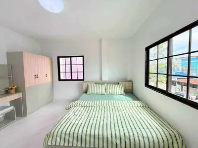 Bright and airy bedroom with modern furnishings and large windows.